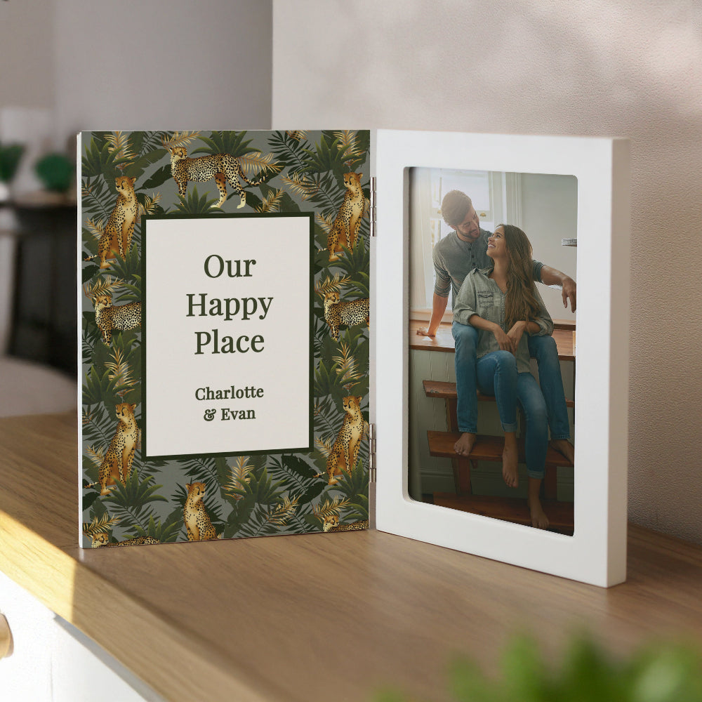 Personalized photo album with a couple on the cover and jungle leaf design.