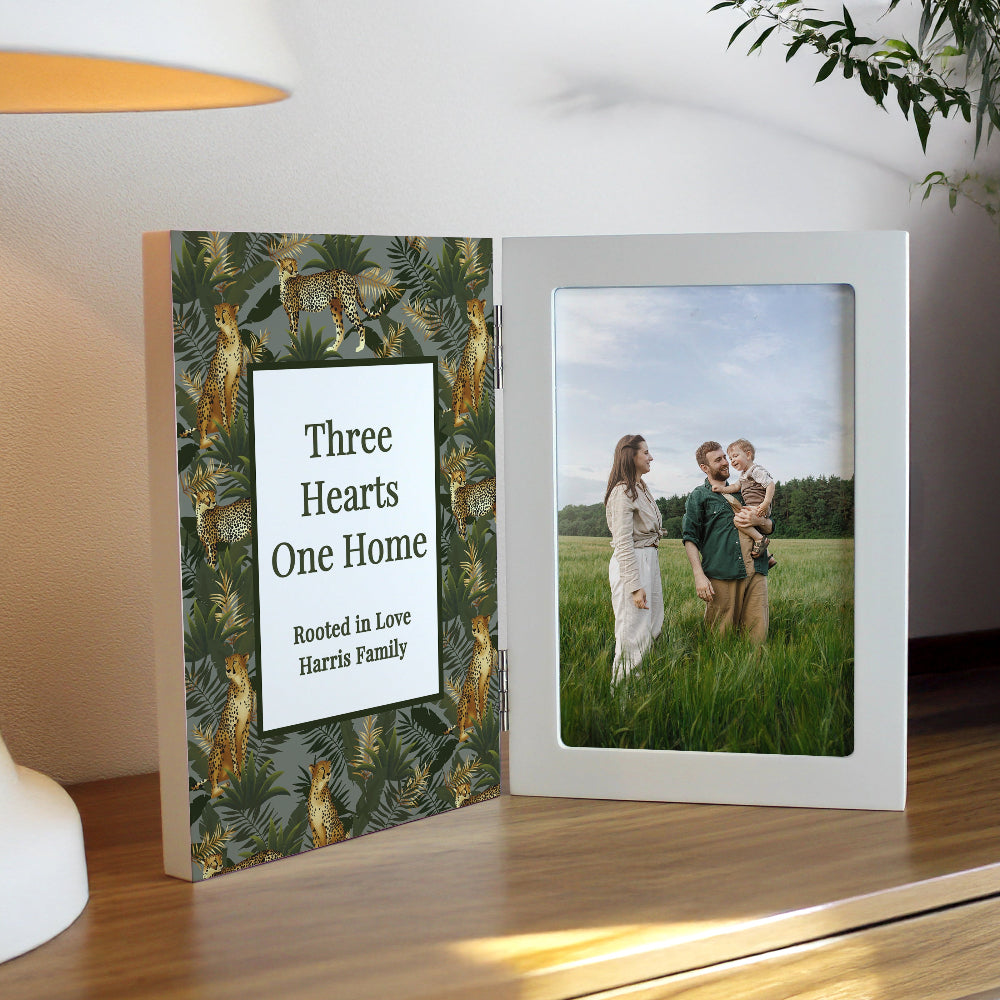 Decorative book with a heart design and a photo of a couple and child on a wooden surface.