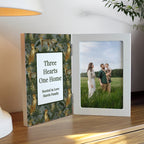 Decorative book with a heart design and a photo of a couple and child on a wooden surface.