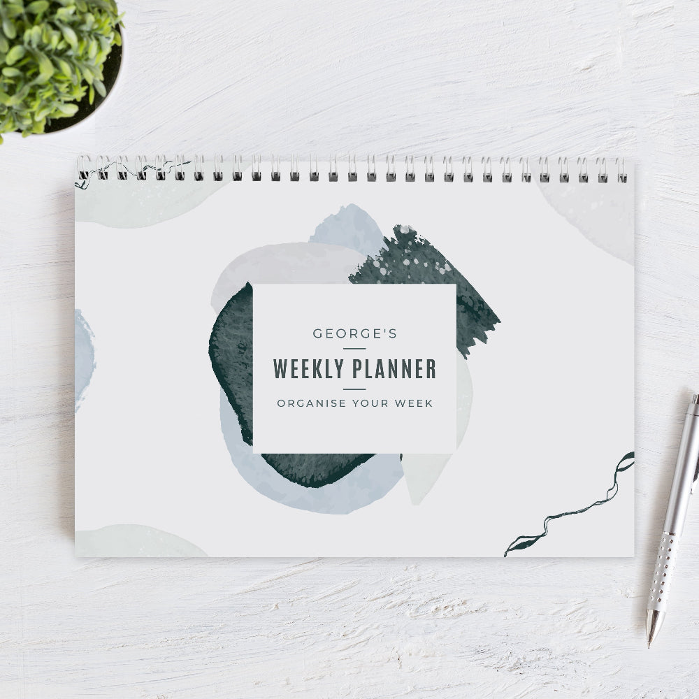 Weekly planner with abstract design on a white surface