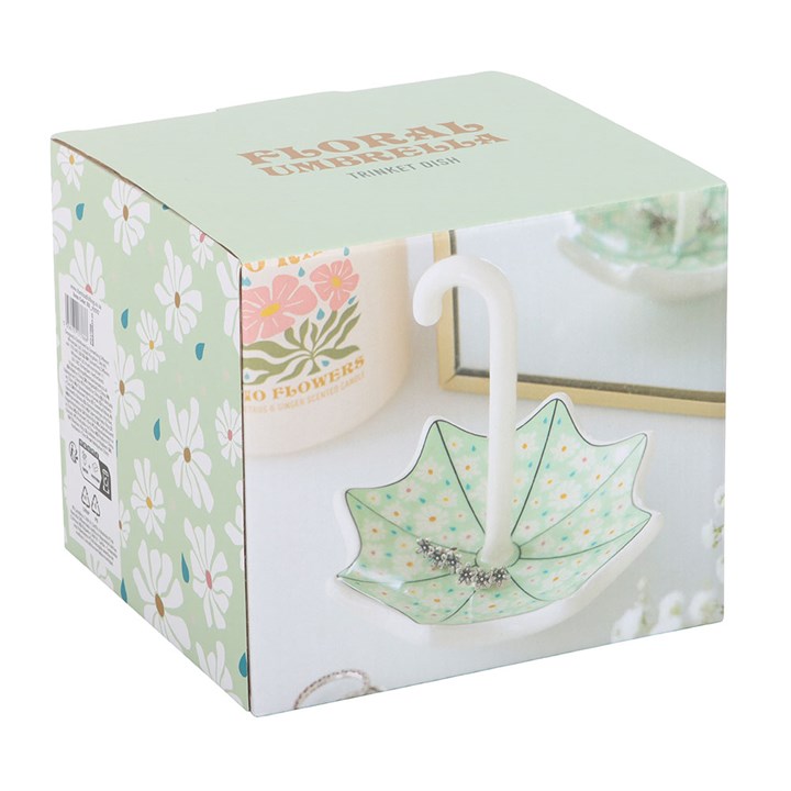 Floral-themed product packaging with a decorative dish and stand.
