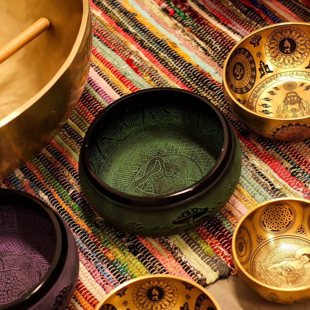 Decorative bowls with intricate designs on a colorful fabric background