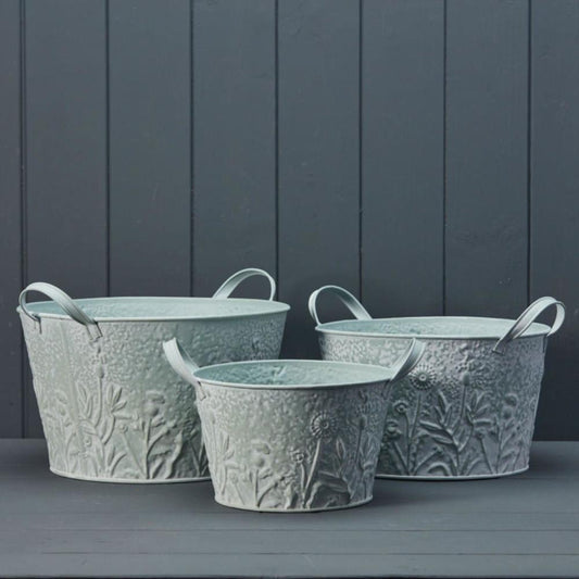 SET OF THREE ROUND ZINC PLANTERS WITH FLORAL DESIGN