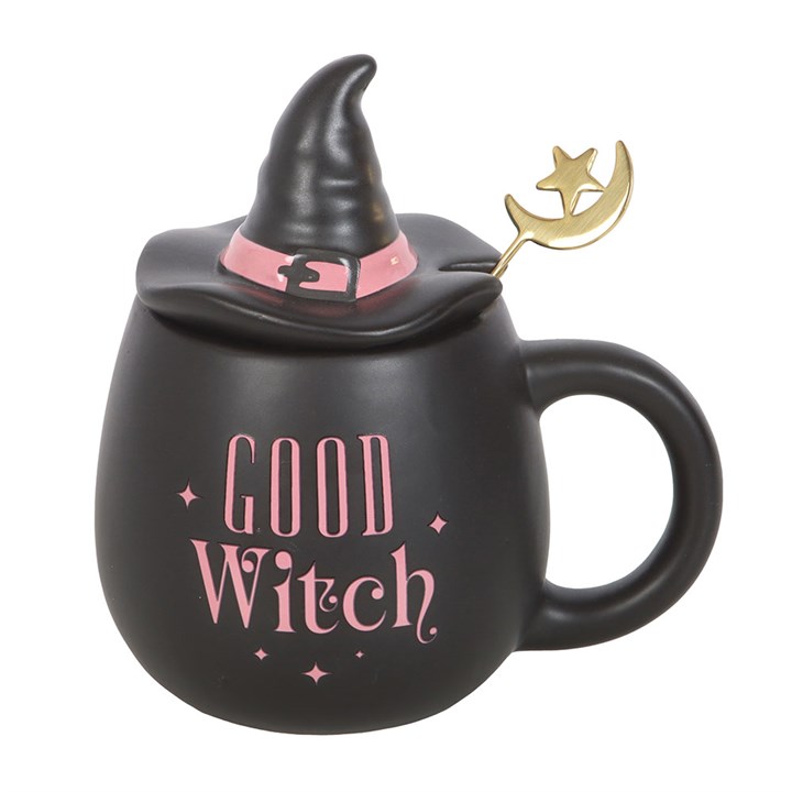 Black mug with witch hat lid, 'Good Witch' text, and gold moon and star decoration on a white background