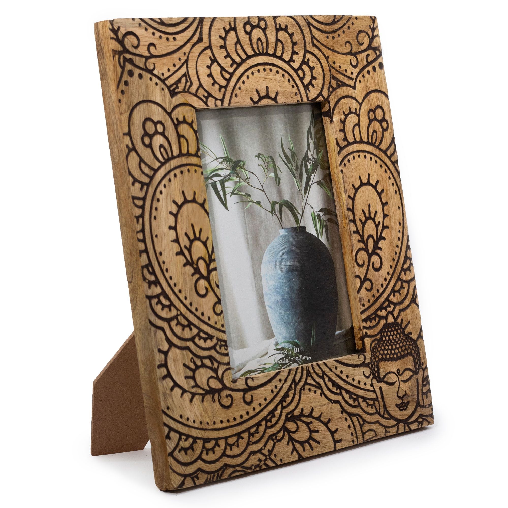 Wooden photo frame with intricate carvings on a white background