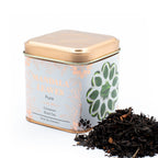 Tea canister labeled 'Mandala Leaves' with tea leaves spilling out on a white background