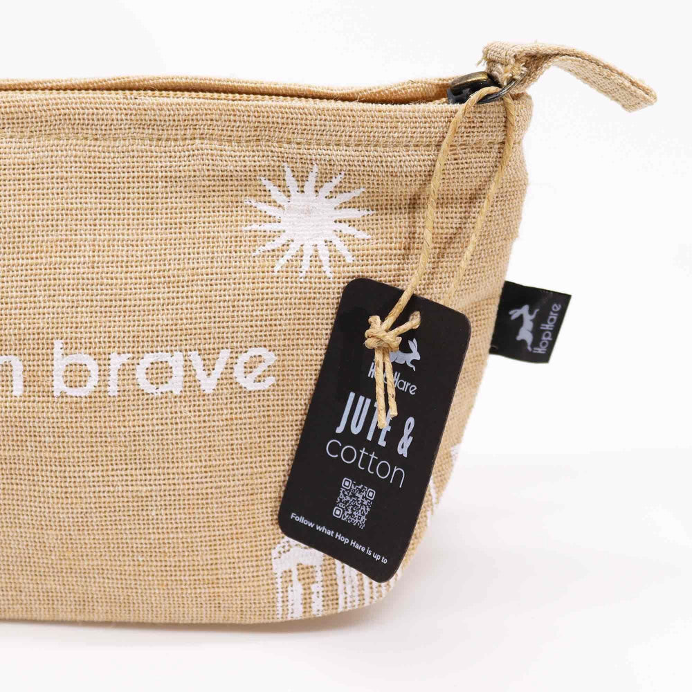 Beige pouch with white star design and 'brave' text, featuring a tag with branding on a white background.