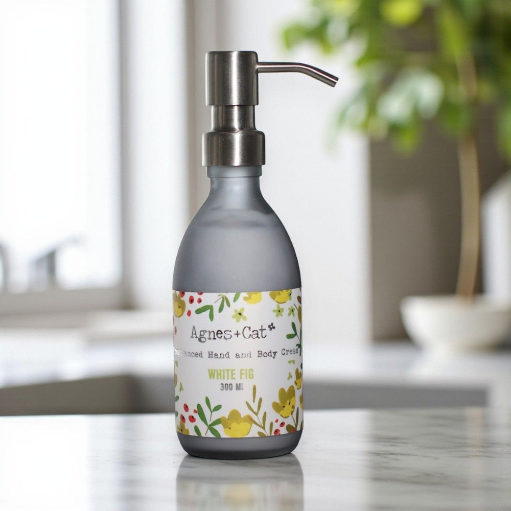 Hand and body cream bottle with floral label on a kitchen counter