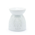 White ceramic oil burner with Buddha face design on a white background