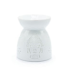 White ceramic oil burner with Buddha face design on a white background