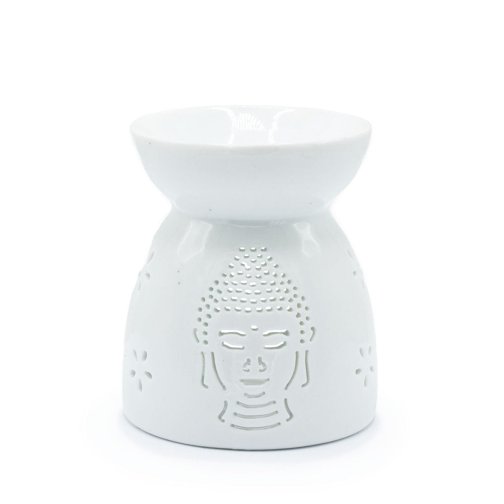 White ceramic oil burner with Buddha face design on a white background