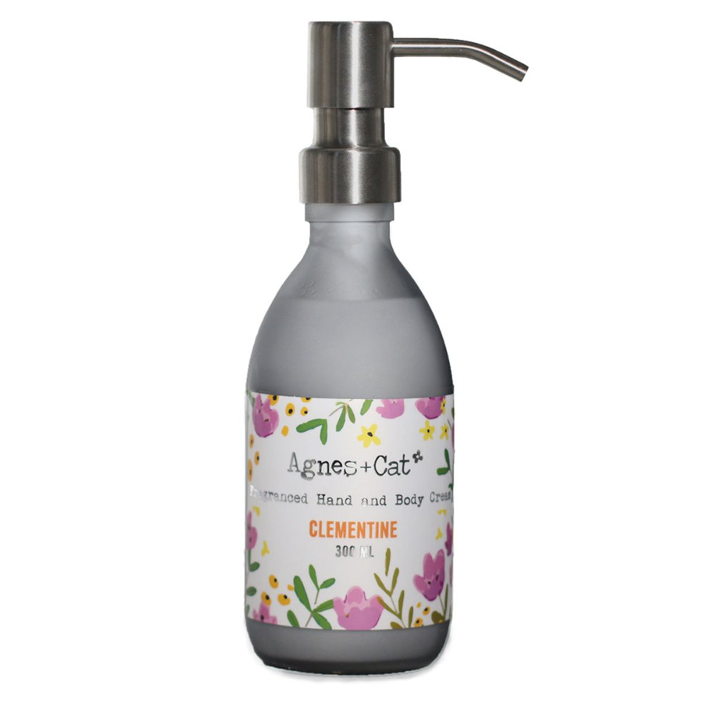 Agnes + Cat Hand soap dispenser with floral label on a white background