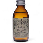 Amber bottle labeled 'Lady of the Lake' with a silver cap on a white background