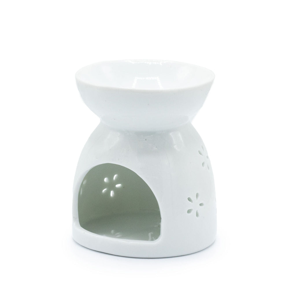 White ceramic oil burner with floral design on a white background