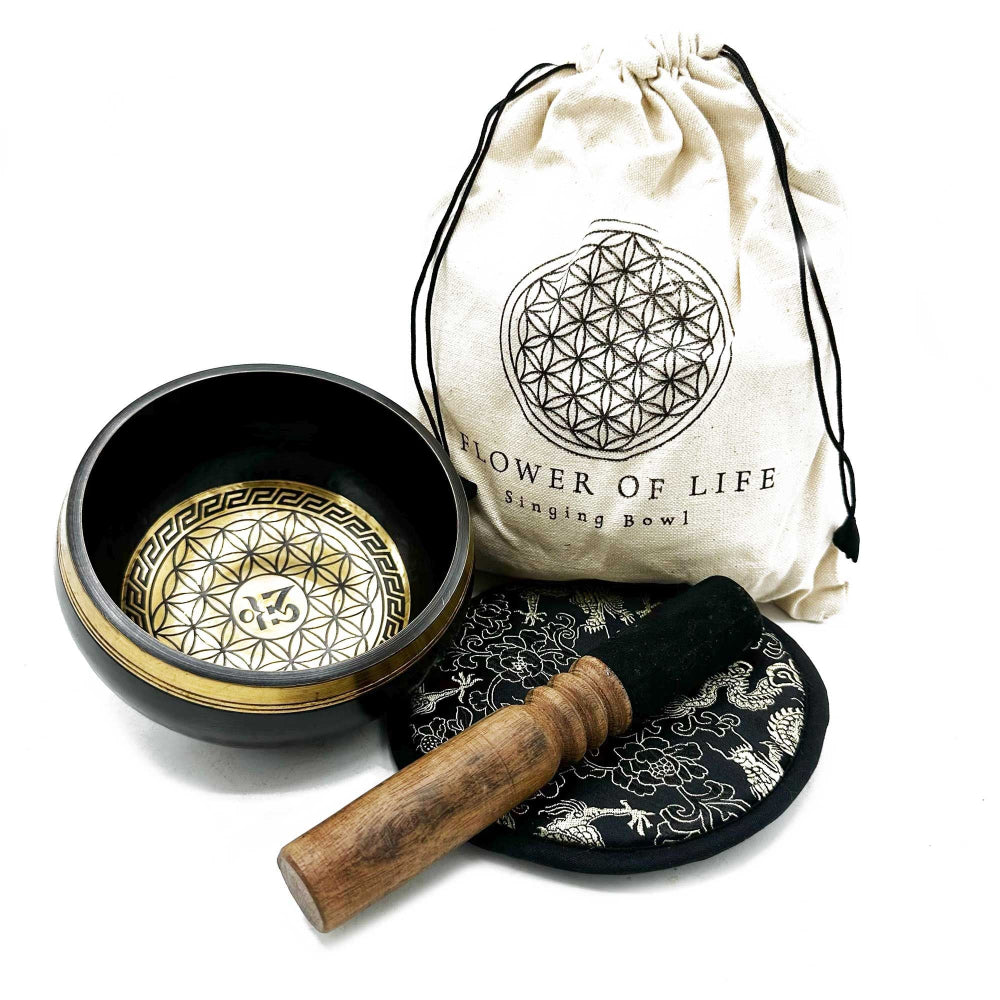 Singing bowl set with a bag labeled 'Flower of Life' on a white background