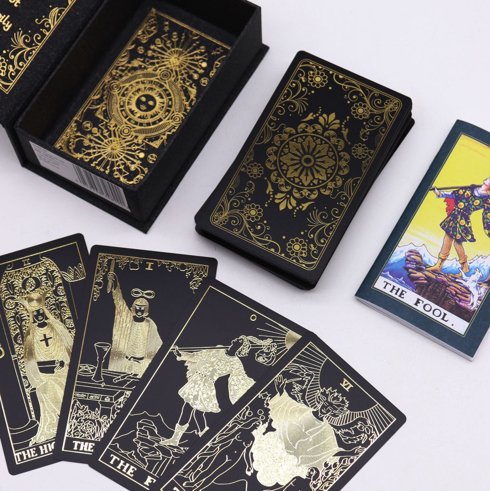 Black tarot cards with gold designs and a few cards displayed on a white background.