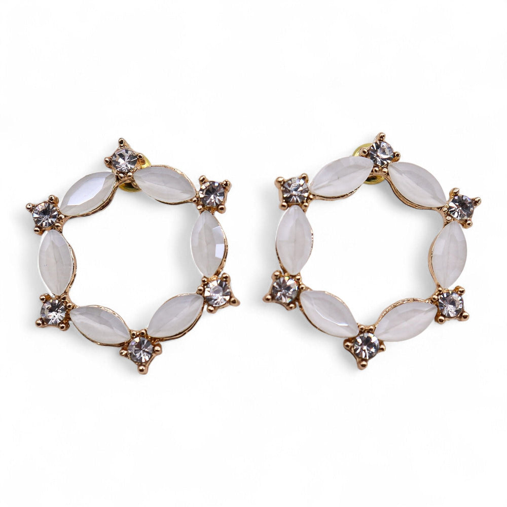 Pair of gold and white hoop earrings on a white background