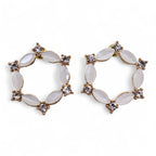 Pair of gold and white hoop earrings on a white background