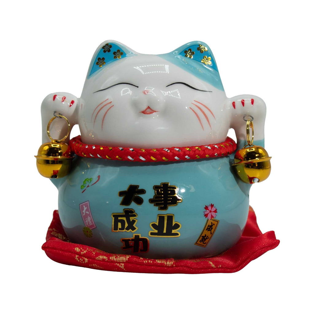 Decorative cat figurine with gold bells on a white background