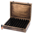 Wooden box with compartments for small bottles, with a few bottles outside on a white background