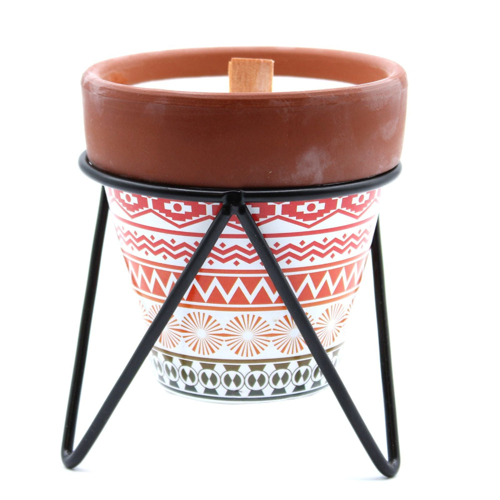Ceramic candle pot with a patterned stand on a white background