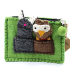 Green felt pouch with owl and mouse plush toys on a white background