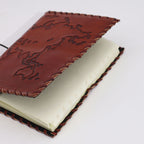 Brown leather-bound notebook on a white background