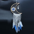 Crescent moon-shaped dreamcatcher with blue and white feathers on a black background
