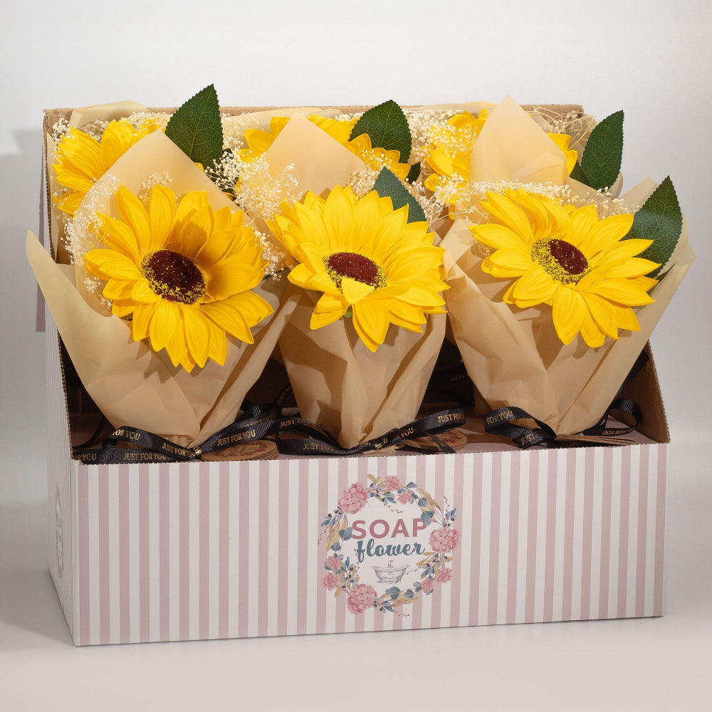 Three sunflower-shaped soap flowers in a box with a visible brand label.