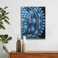 Blue Buddha artwork on a white wall above a wooden cabinet with candles and a plant.
