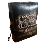 Black leather-bound book with 'The Stories I Tell Myself' embossed on it, on a white background