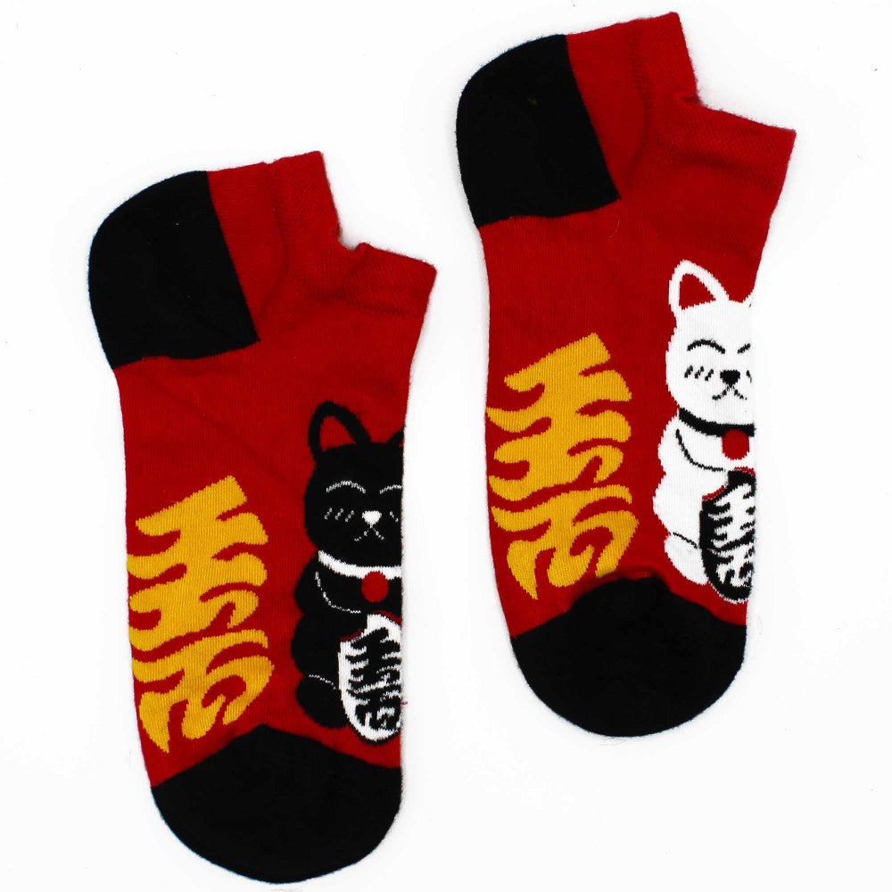 Red socks with black cat and yellow text design on a white background