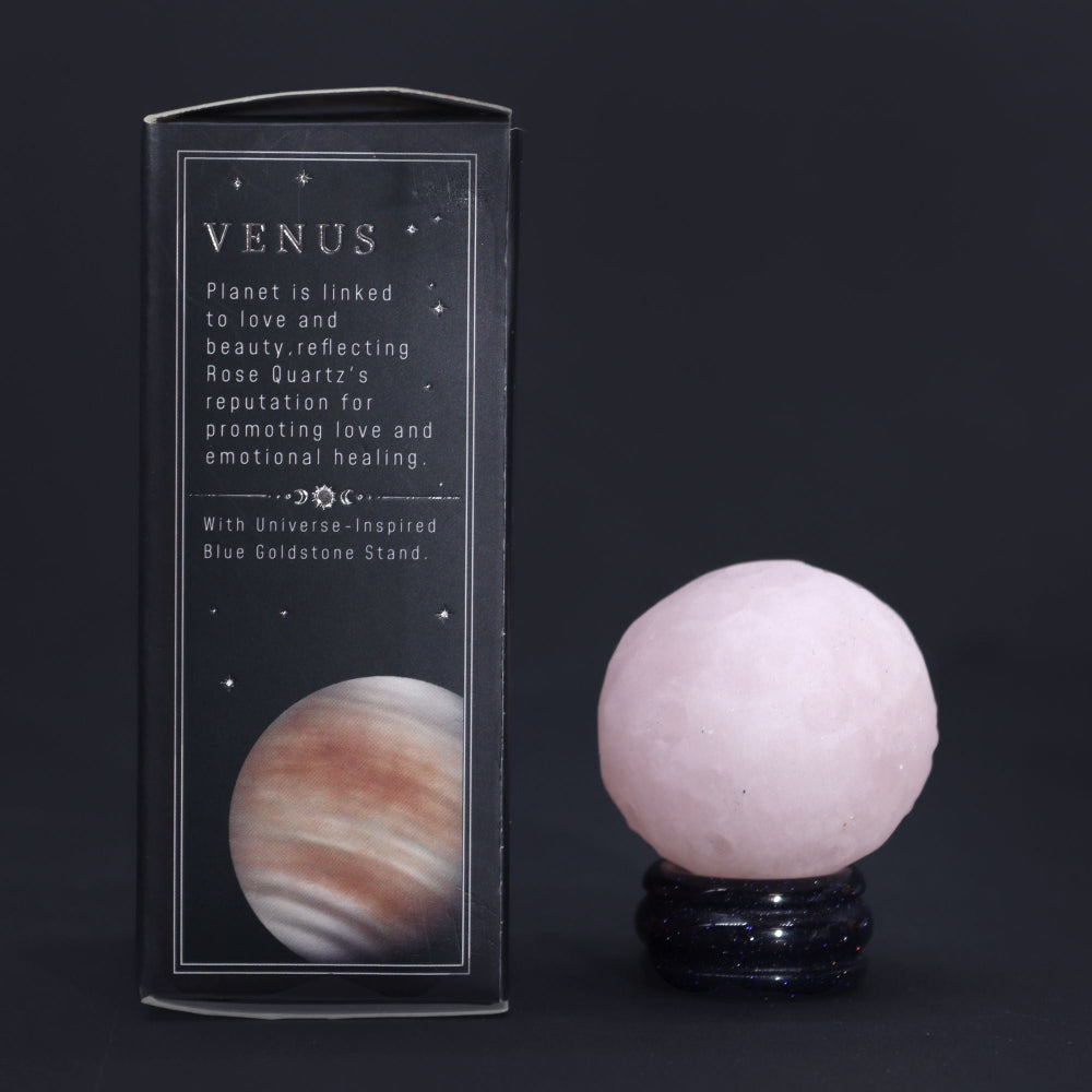 Rose Quartz crystal ball with packaging on a dark background