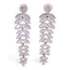 Pair of white leaf-shaped earrings on a white background