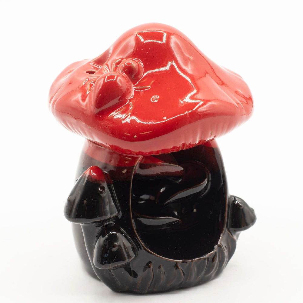 Black and red ceramic mushroom-shaped object on a white background