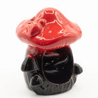 Black and red ceramic mushroom-shaped object on a white background
