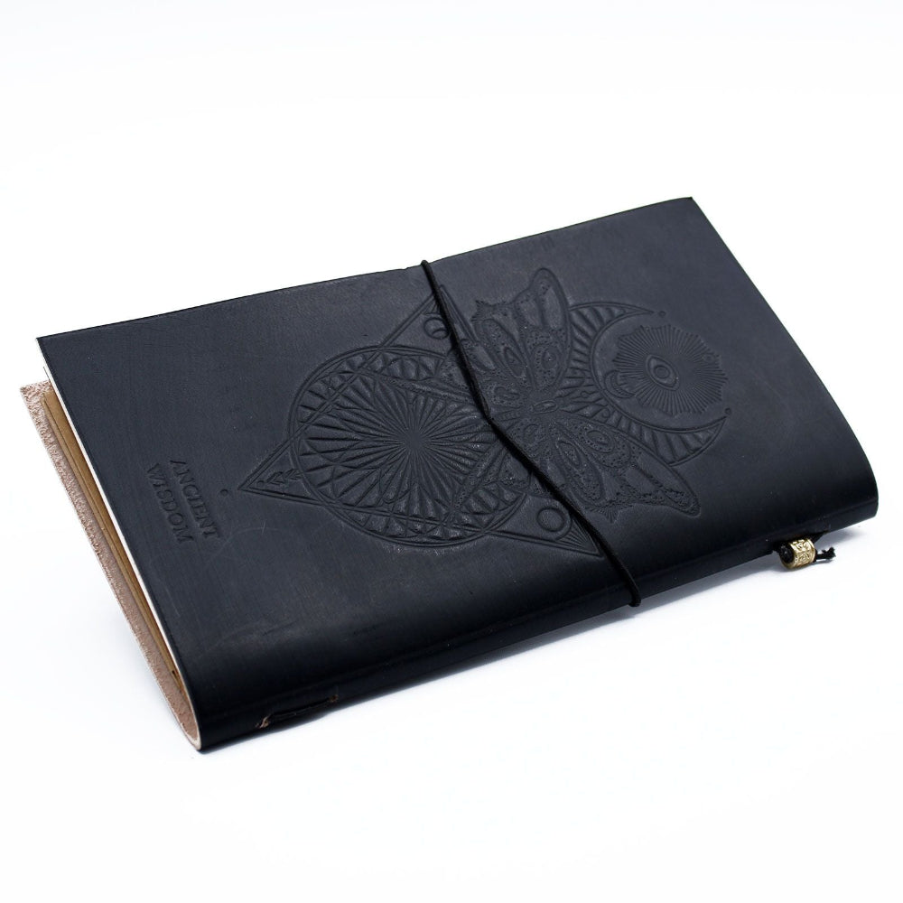Black leather notebook with embossed design on a white background