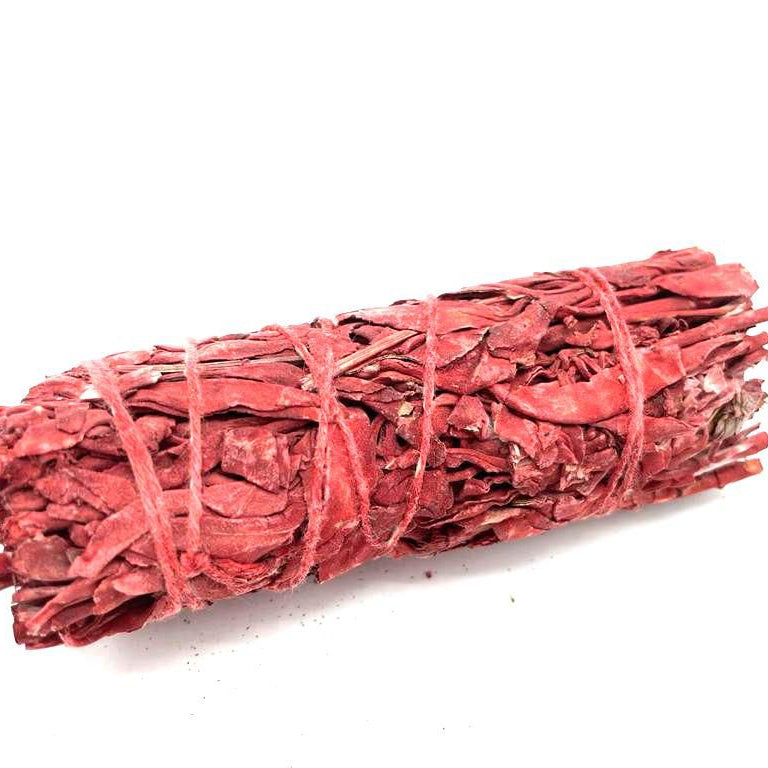 Red incense bundle tied with string on a white background
