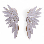 Pair of white leaf-shaped earrings on a white background