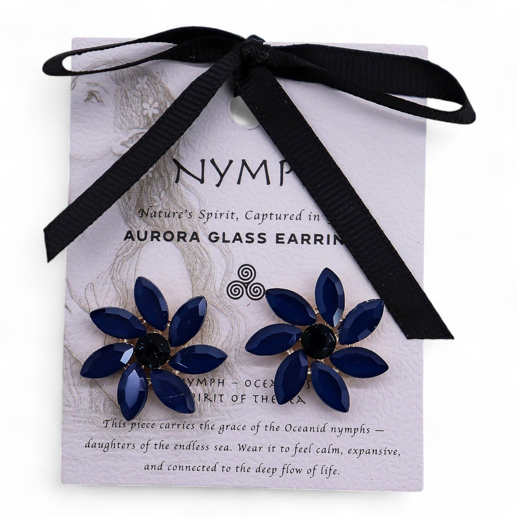 Navy blue flower earrings on a white card with black ribbon, featuring the brand 'NYMP'.