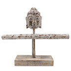 Wooden Buddha head sculpture on a stand with a white background