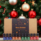Set of Christmas fragrance oils with a decorative box against a Christmas tree background