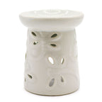 White ceramic oil burner with a textured design on a white background