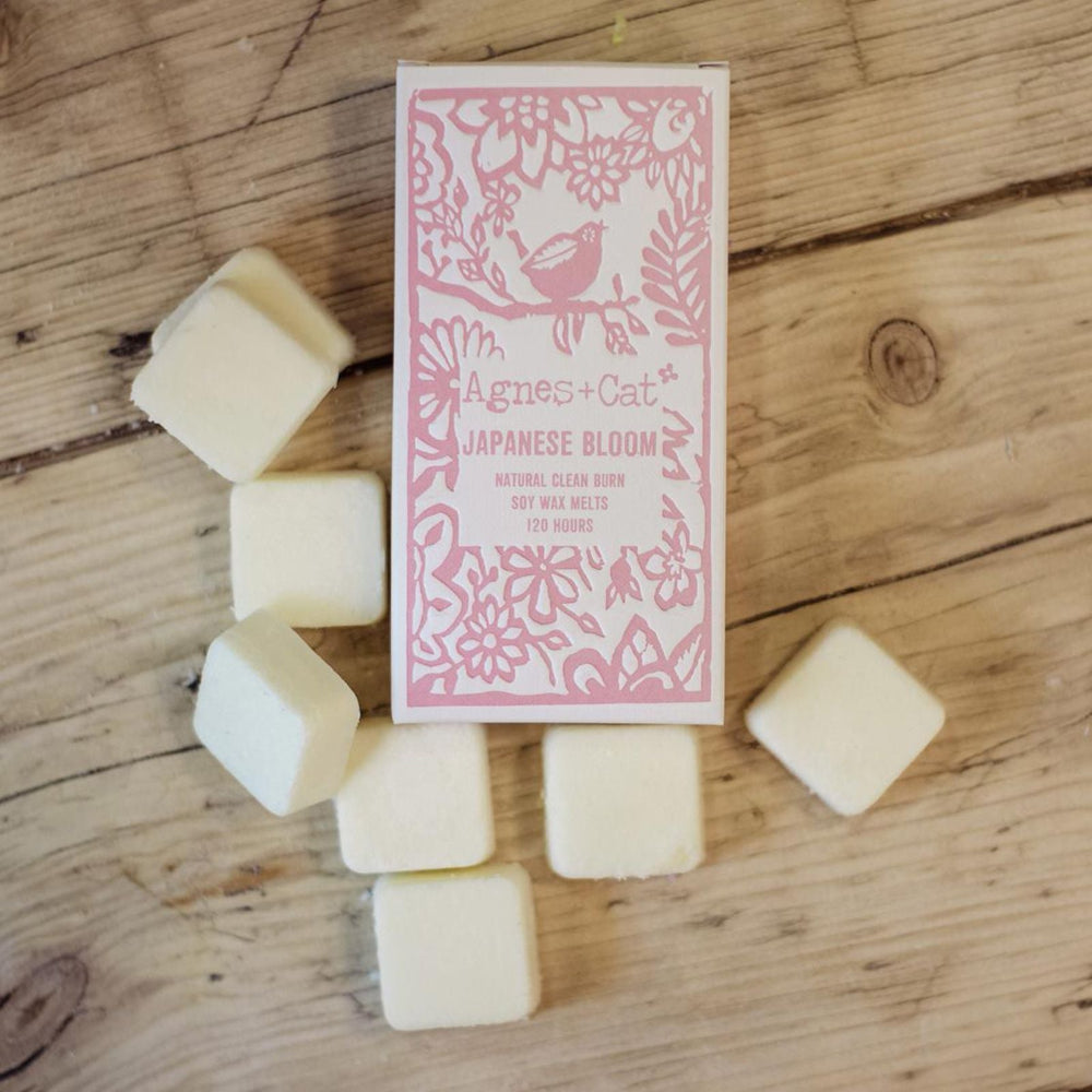A package of Agnes & Cat Japanese Bloom wax melts on a wooden surface.