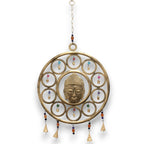 Decorative wall hanging with Buddha face design on a white background