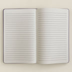 Open notebook with lined pages on a light beige background