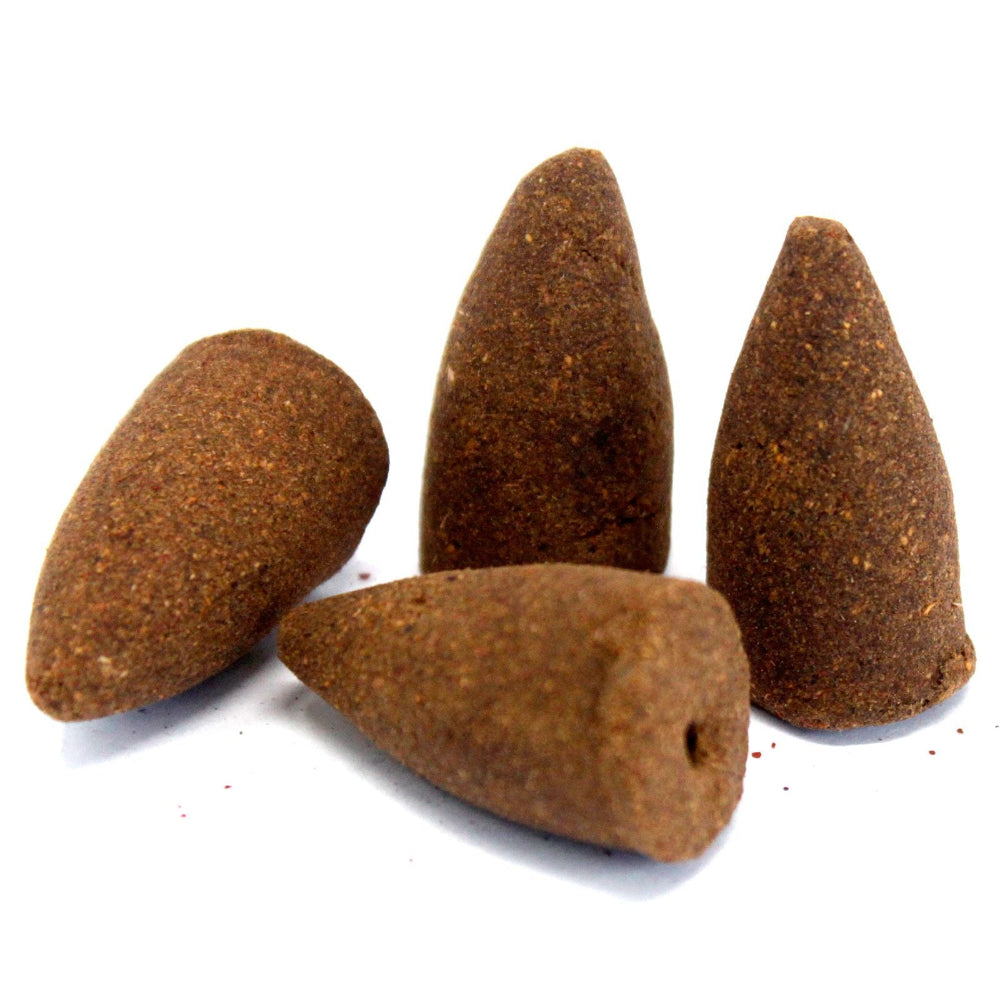 Four brown incense cones on a white background