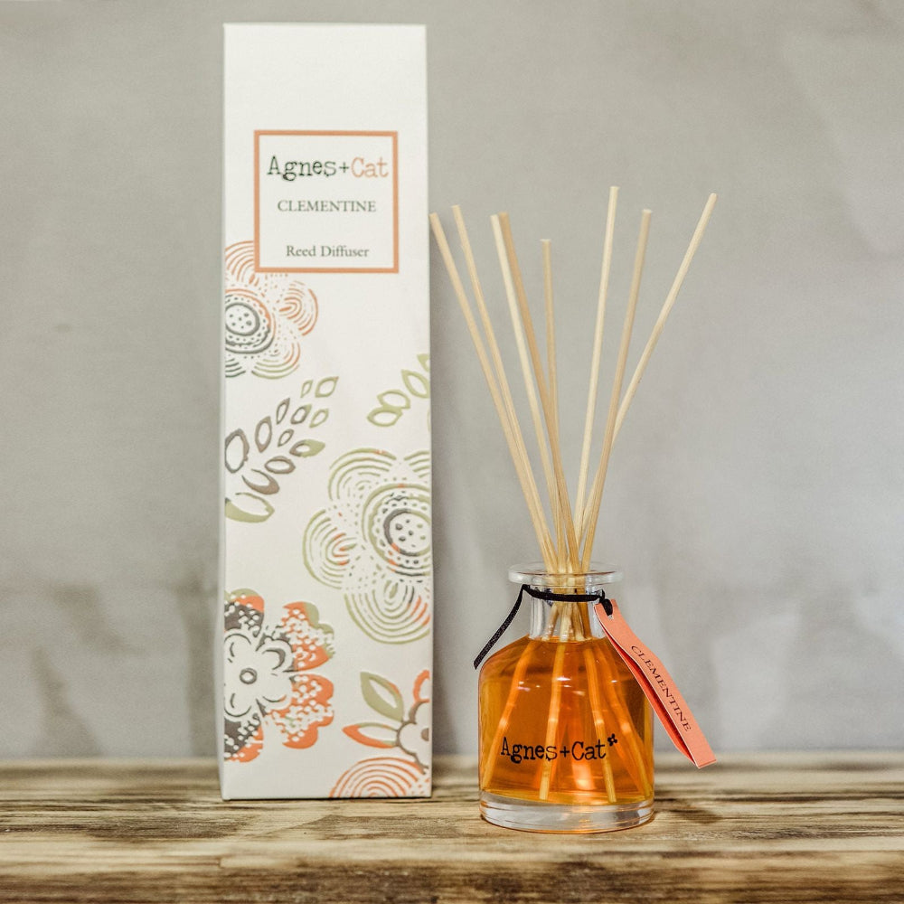 Agnes + Cat Clementine reed diffuser with packaging on a wooden surface