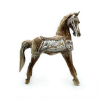 Wooden horse figurine with decorative patterns on a white background