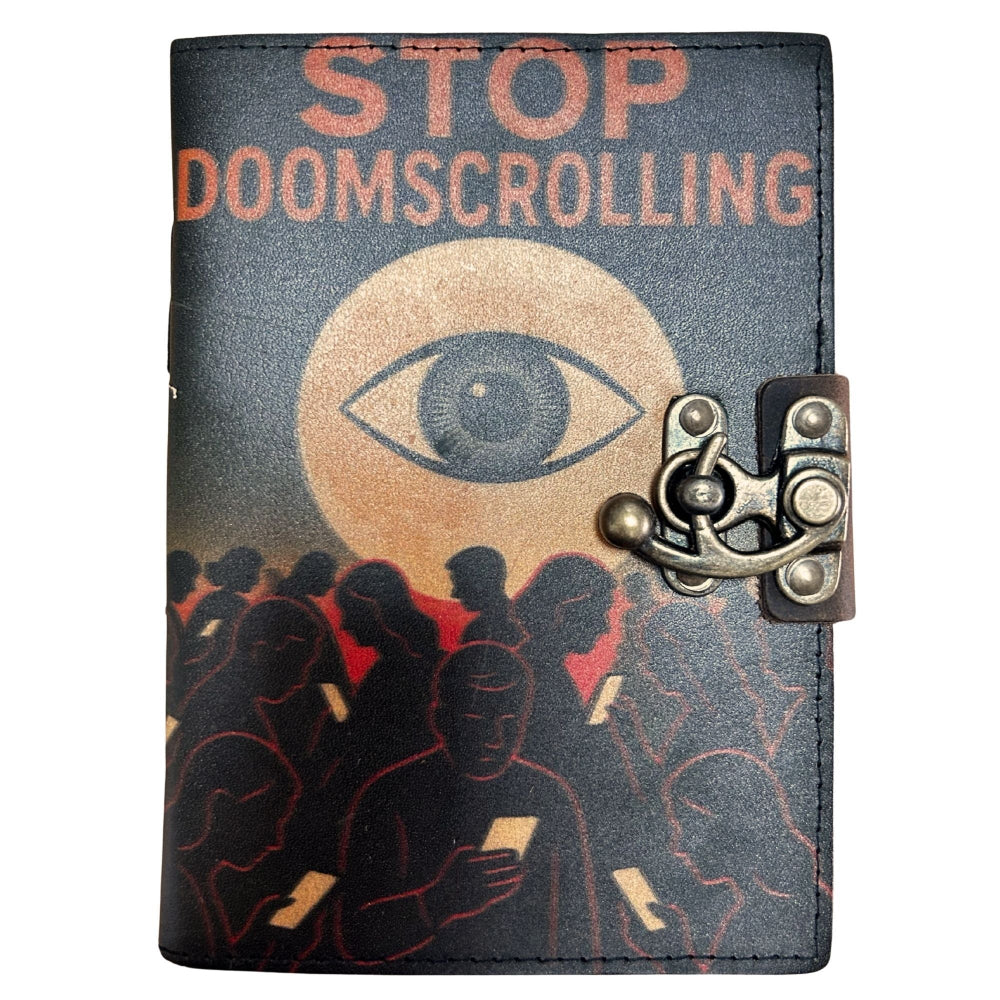 Notebook with 'STOP DOOMSCROLLING' text and eye design on a dark background
